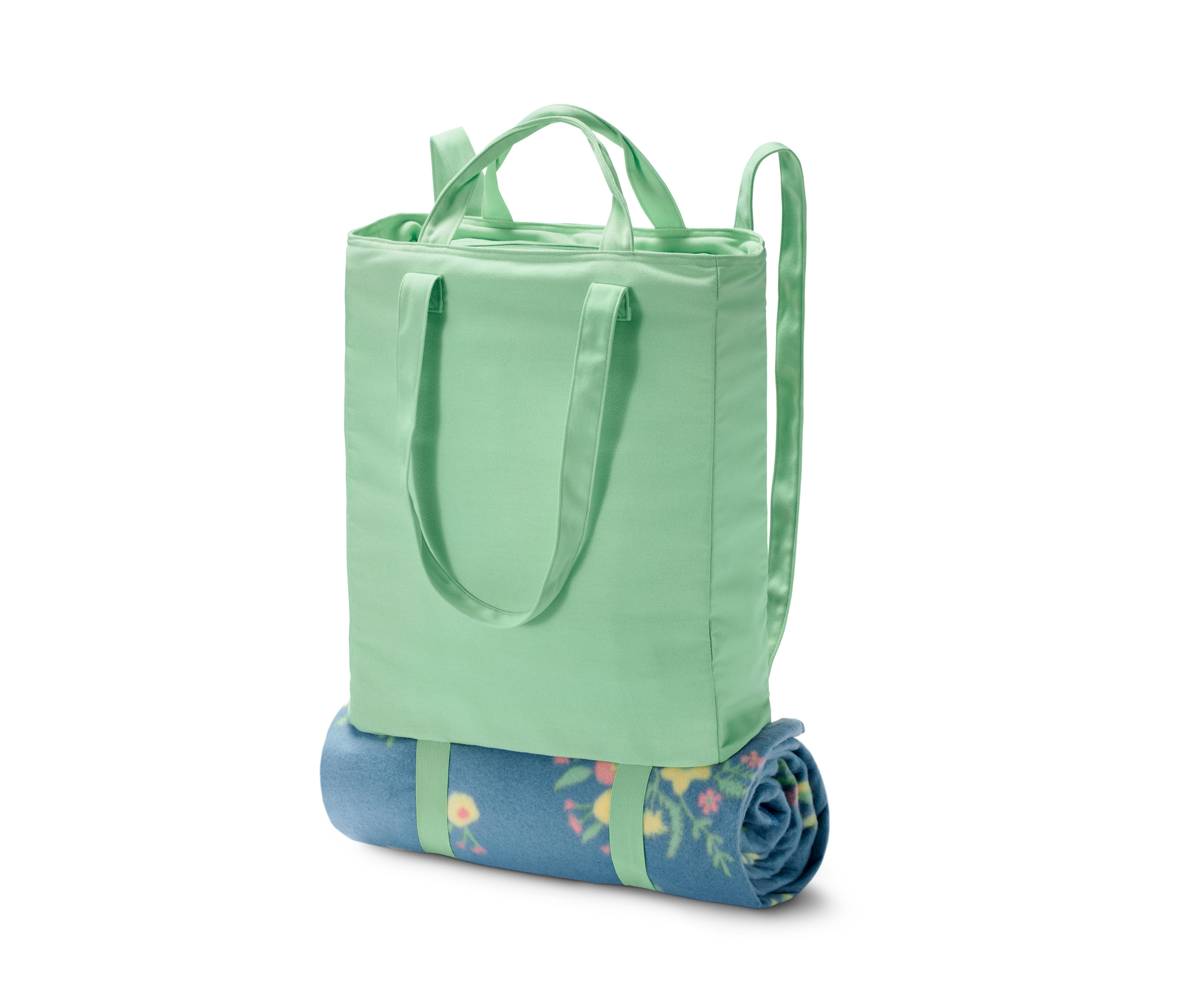 Zelená chladiaca taška a ruksak 2 v 1 so zrolovanou modrou dekou s kvetinovým vzorom.