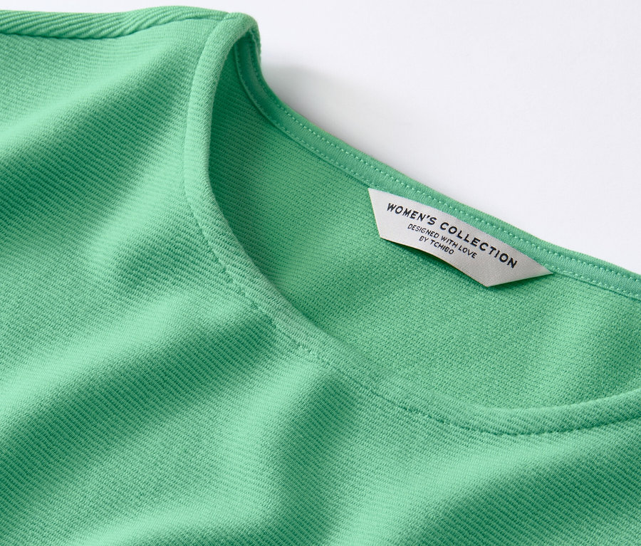 Detail zeleného blúzkového trička.