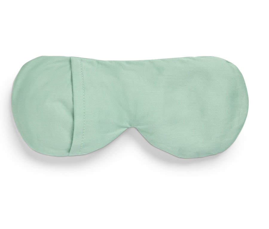 Svetlozelená maska na spanie leží na bielom pozadí.