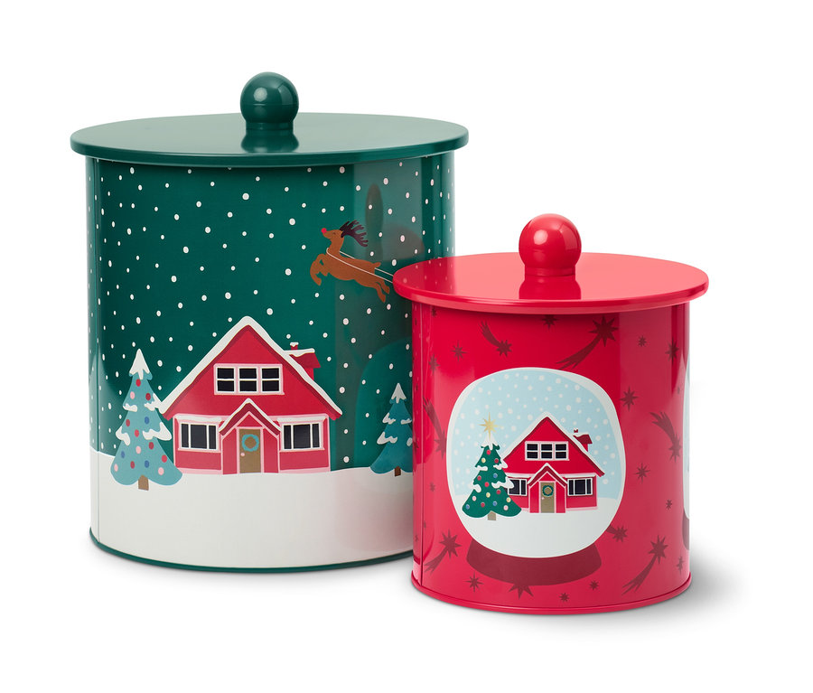 Dve dózy na keksy s vianočnými motívmi domov a stromov.