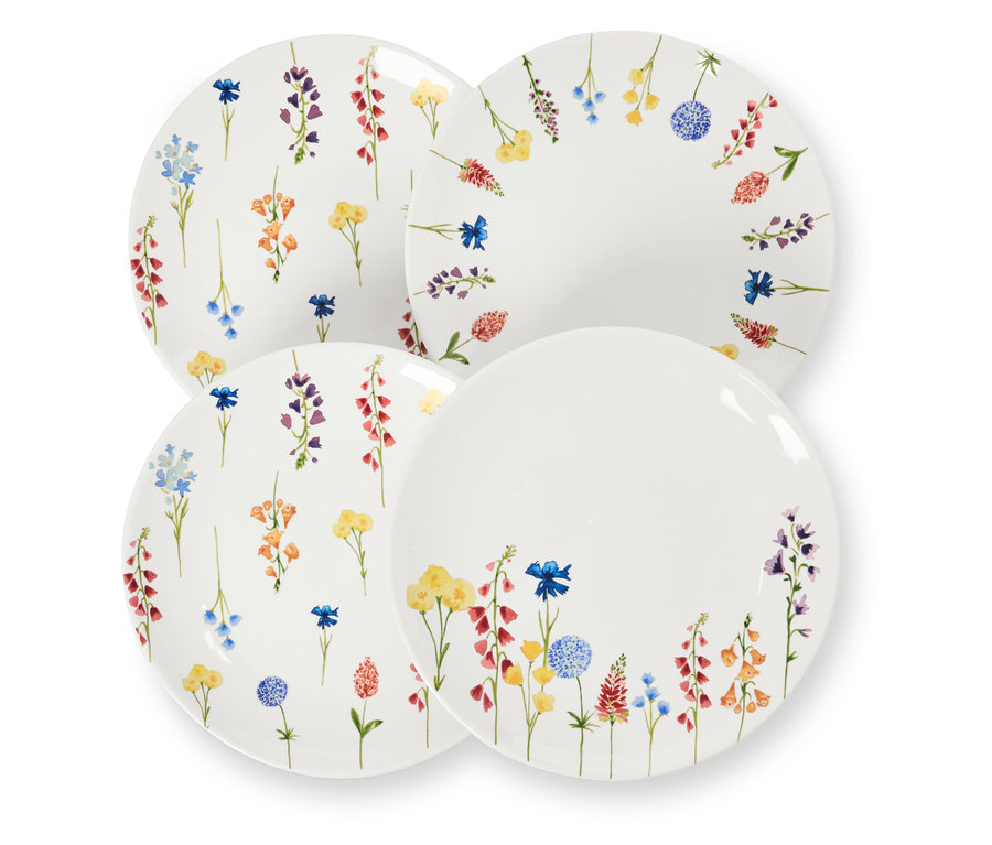 Štyri dezertné taniere s kvetinovým dekorom ležia na sebe.