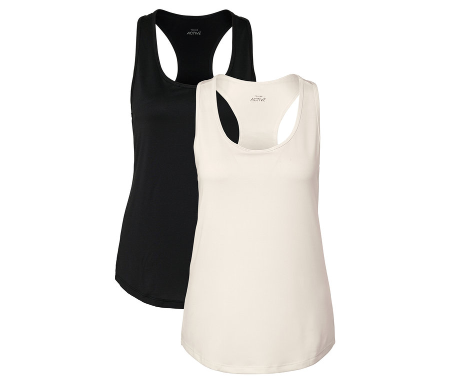 Dve tielka, jedno čierne a jedno krémové, ležia vedľa seba.