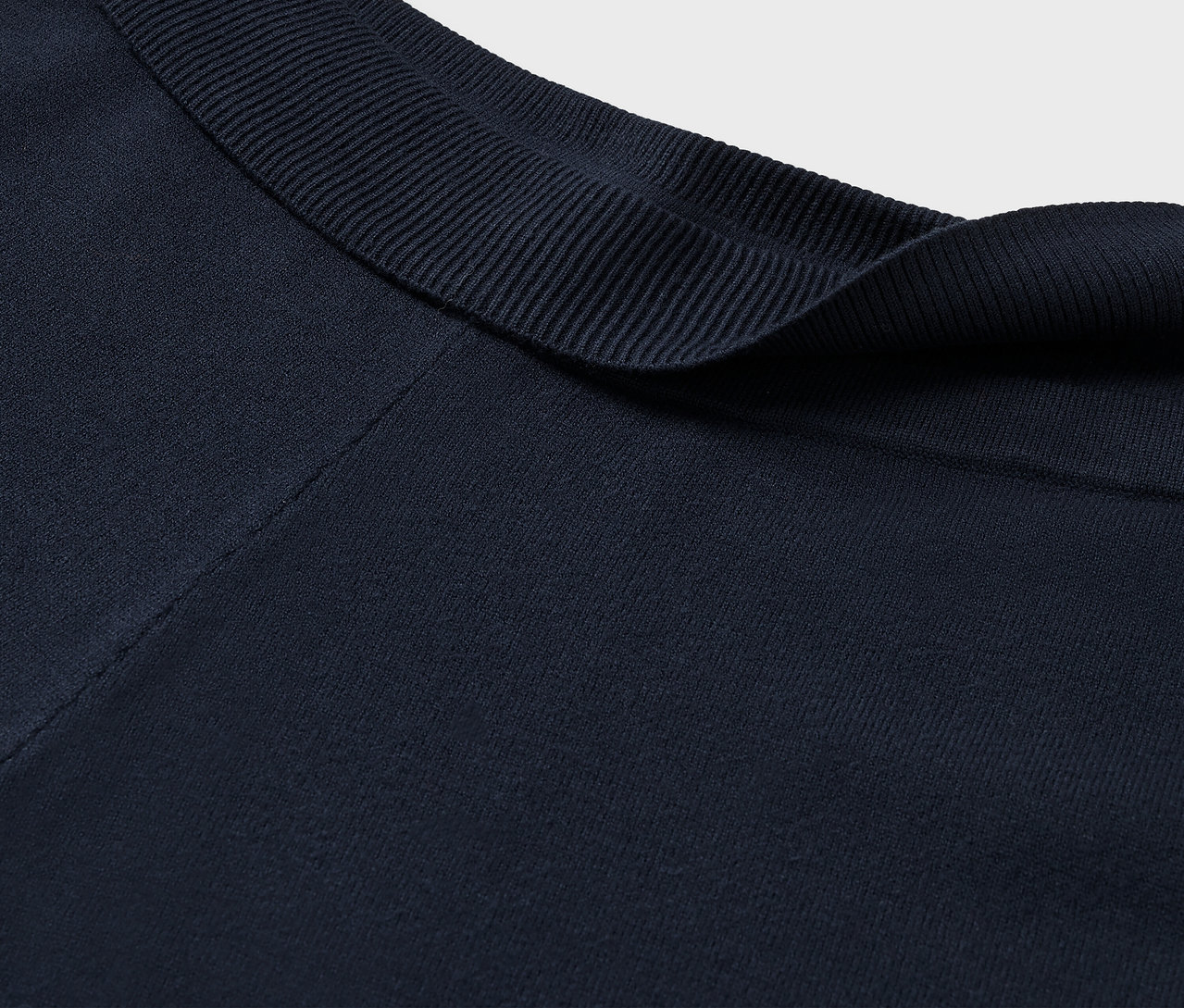 Detailný záber na tmavomodrý látkový golier s rebrovanou textúrou.