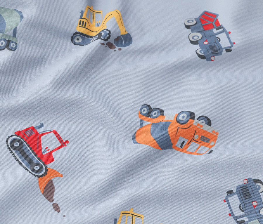 Na svetlomodrej látke sú zobrazené rôzne stavebné vozidlá.