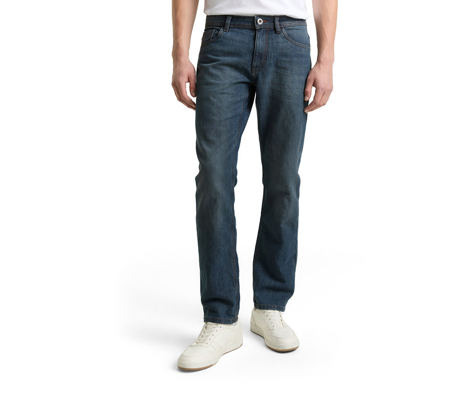 Muž má na sebe džínsy Tom Tailor TT MARVIN STRAIGHT Jeans mit Stretch, Mid Stone Blue Grey Denim a biele topánky.