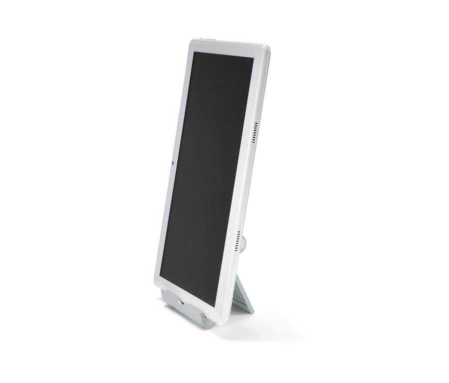 Biely tablet stojí na stojane na smartfón a tablet.