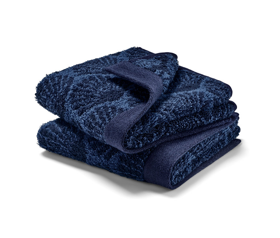 Dva zložené uteráky pre hostí »Muschel«.