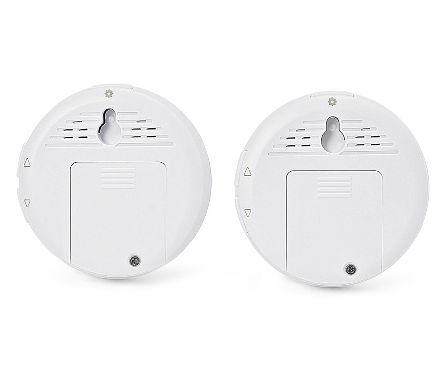 Dva biele okrúhle senzory s držiakmi na stenu a krytmi batérií.