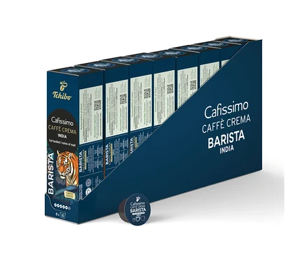 Tmavomodrý displejový box s 80 kávovými kapsulami Cafissimo BARISTA Caffè Crema India, vpredu jedna voľná kapsula. Na boxe je zobrazená hlava tigra.