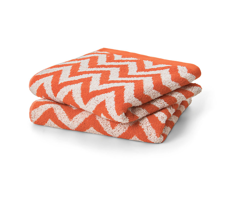 Dva oranžové žakárové uteráky zložené na sebe.