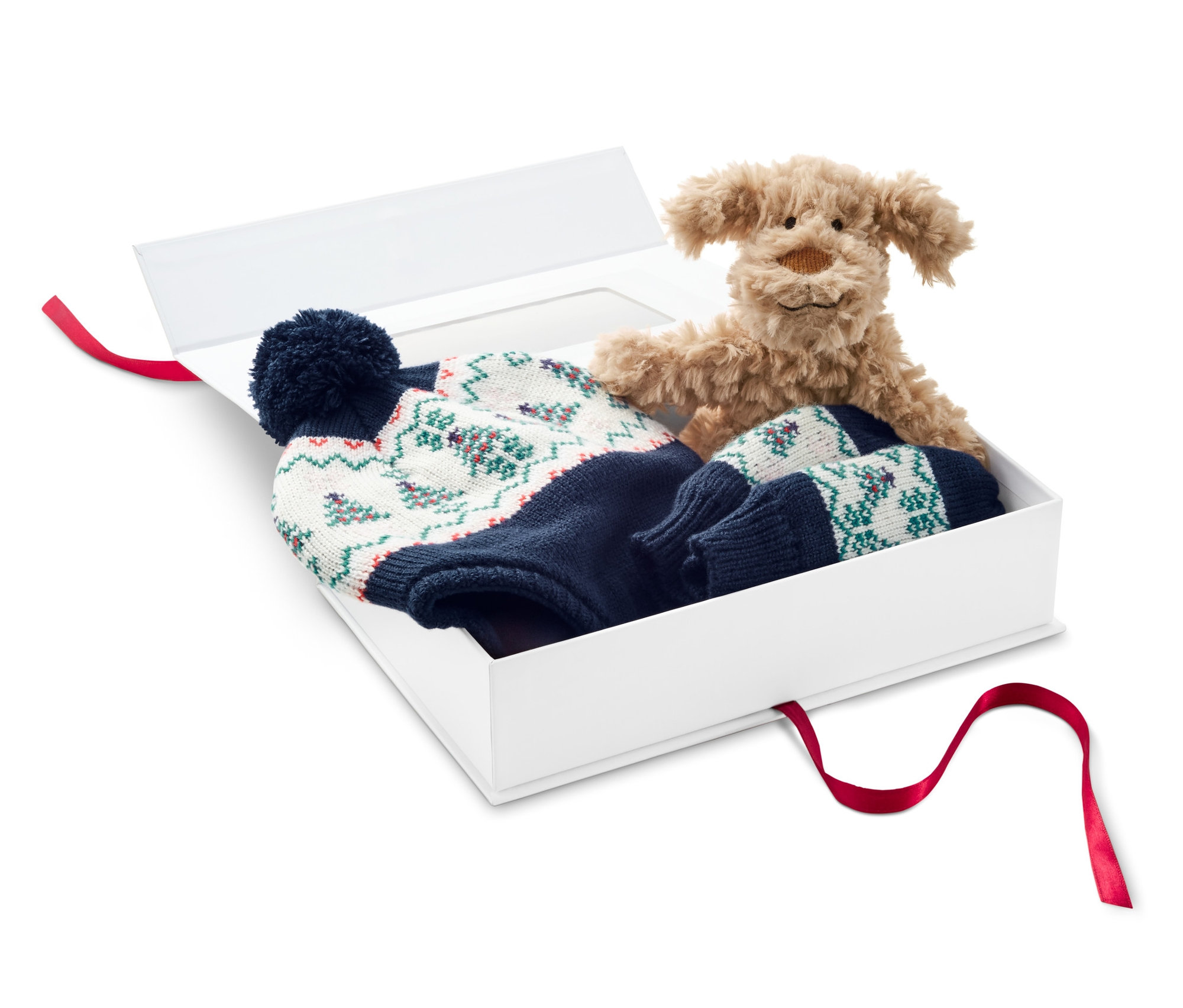 Plyšový pes a 3-dielna darčeková súprava pre deti v bielej darčekovej krabici.