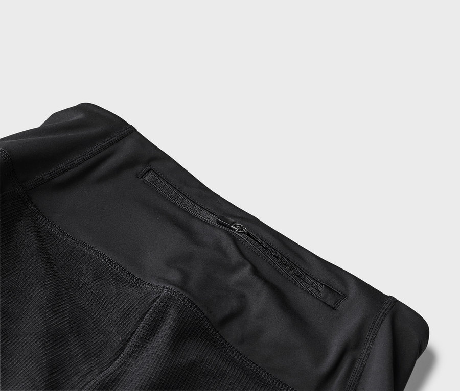 Detailný pohľad na čiernu športovú bundu s vreckom na zips.