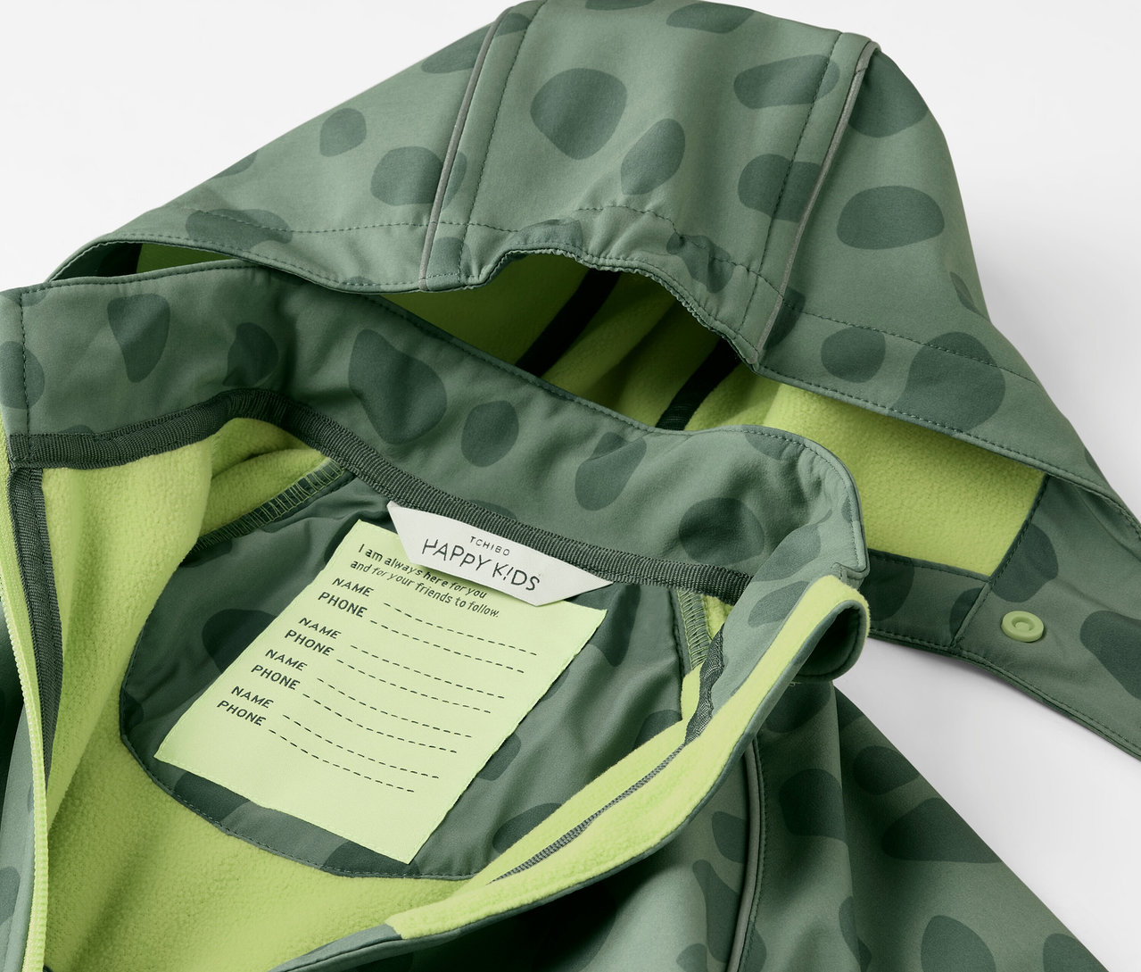 Detail detskej softshellovej kombinézy s kapucňou a štítkom na meno.