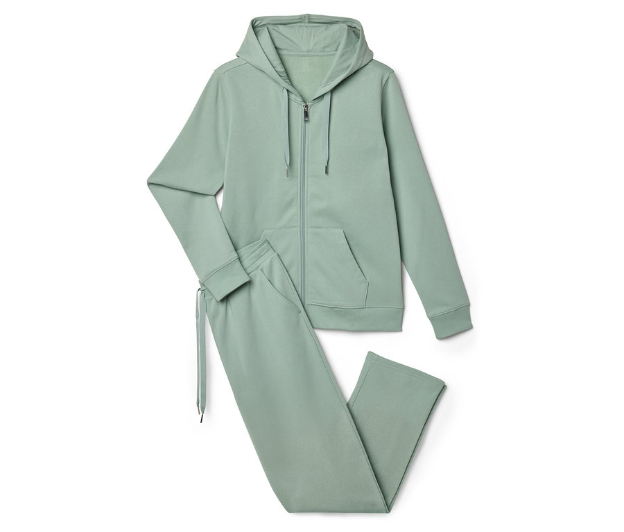 Svetlozelená tepláková súprava pozostávajúca z mikiny na zips s kapucňou a teplákov leží na bielom pozadí.