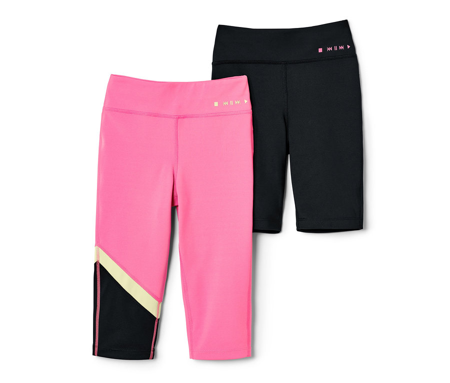 Dvoje detské športové legíny. Jedny ružové a trojštvrťové, druhé čierne a cyklistické.