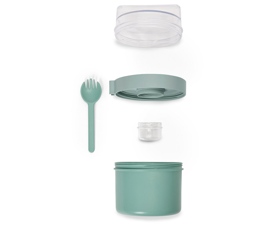 Rozložená zelená nádoba na potraviny s vidličkou a priehľadným vekom.