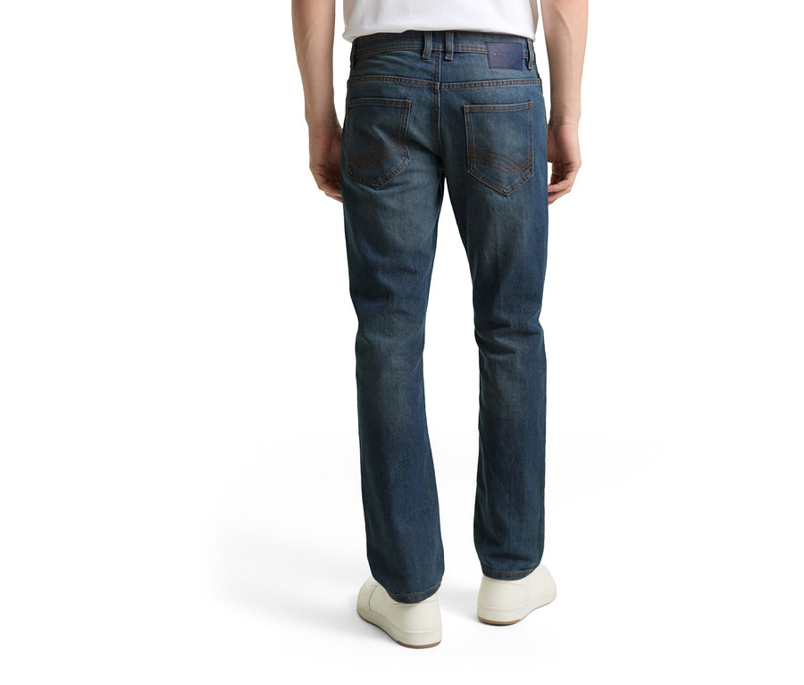 Pohľad zozadu na osobu v džínsoch Tom Tailor TT MARVIN STRAIGHT s pružným materiálom, Mid Stone Blue Grey Denim a bielych topánkach.