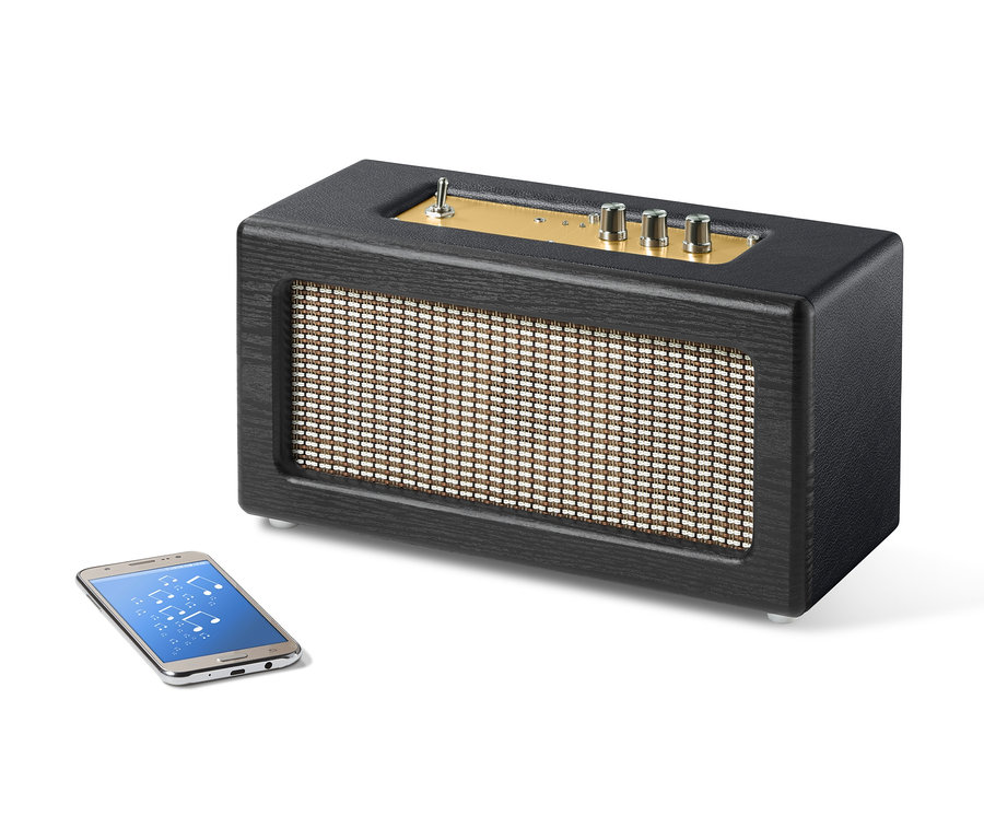Čierny retro Bluetooth® reproduktor vedľa smartfónu.