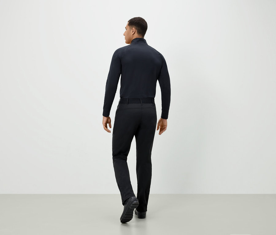 Muž v čiernom oblečení otočený chrbtom.