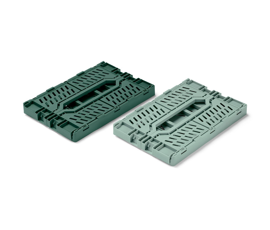 Dve sklápacie úložné debničky, jedna tmavozelená a jedna svetlozelená, sú zložené na bielom pozadí.