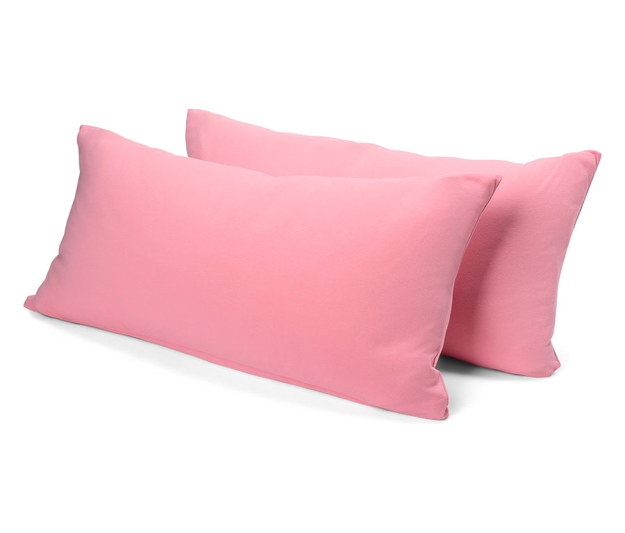 Dva ružové vankúše ležia na sebe.