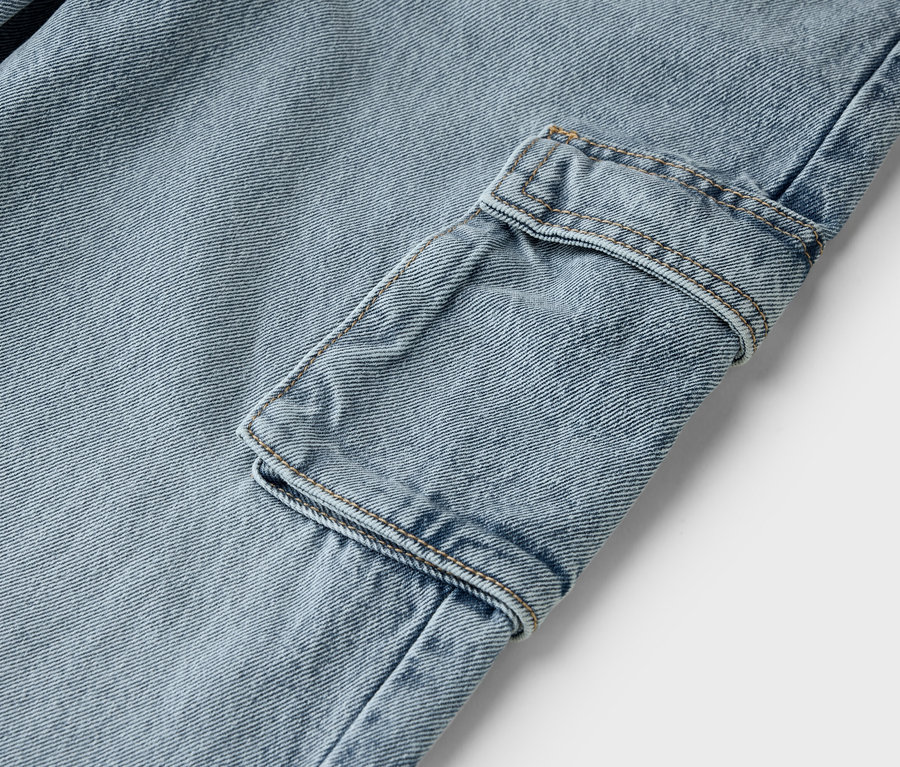 Detail svetlomodrých džínsov s cargo vreckom.