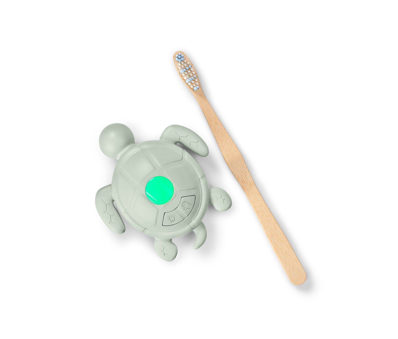 Časovač umývania rúk a zubov v tvare korytnačky so zeleným svetlom a drevená zubná kefka.