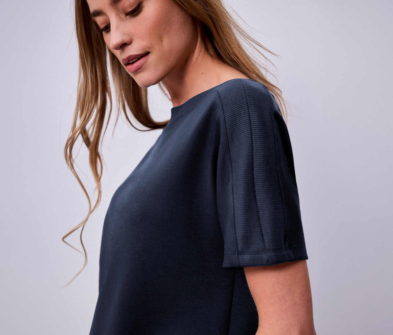 Žena má na sebe námornícke modré tričko s krátkym rukávom Street One.