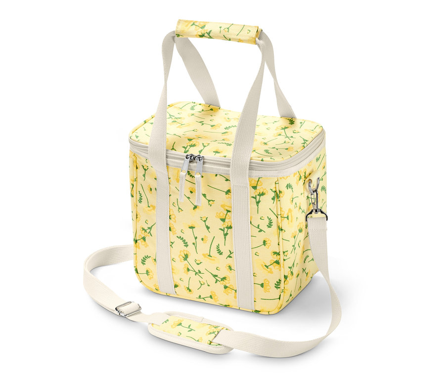 Žltá chladiaca taška s kvetinovým vzorom a bielymi popruhmi.