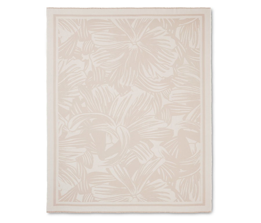 Krémová deka s kvetinovým vzorom a lemom.