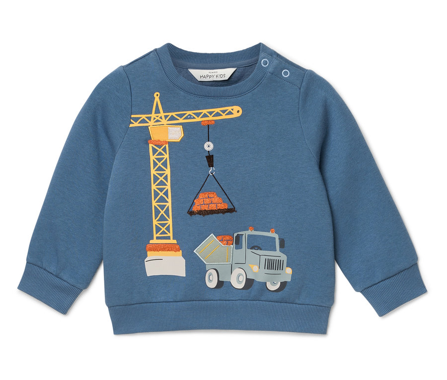 Modrý sveter s obrázkom žeriavu zdvíhajúceho tehly a nákladného auta pod ním.
