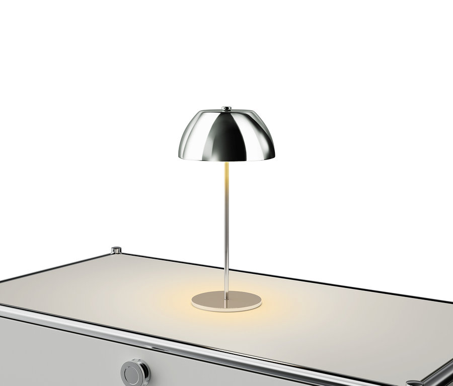 Strieborná lampa na bielom stole.
