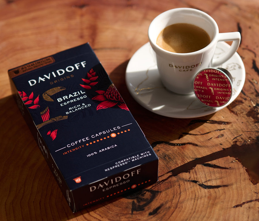 Na drevenom stole stojí balenie DAVIDOFF CAFÉ ORIGINS Brazil Espresso, šálka espressa a kapsula.