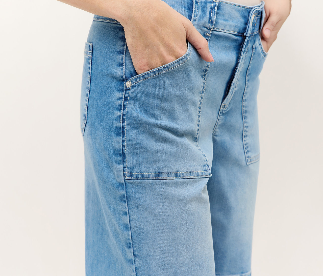Osoba v modrých šortkách Angels Denim »Lia Urban« s rukami vo vreckách.