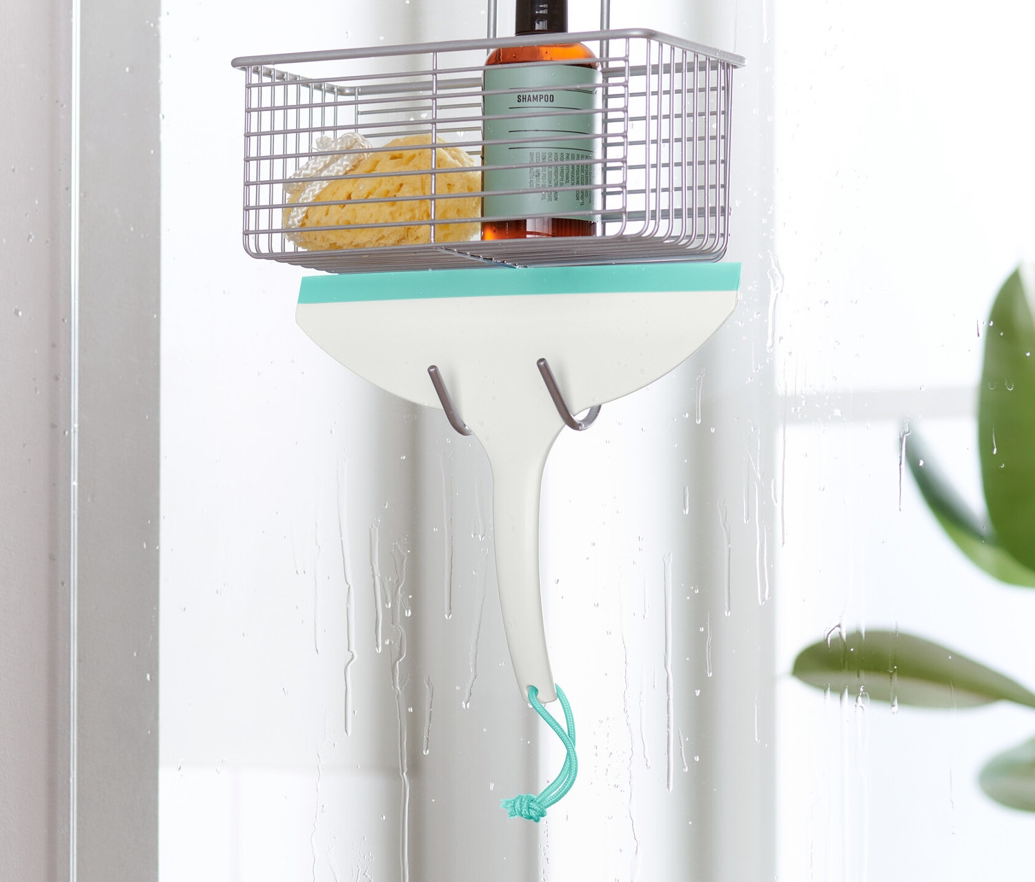 Kúpeľňová stierka visí na sprchových dverách.