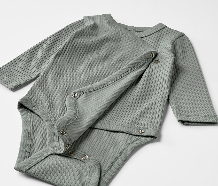 Dve sivé zelené rebrované body s dlhým rukávom pre bábätká ležia na sebe.