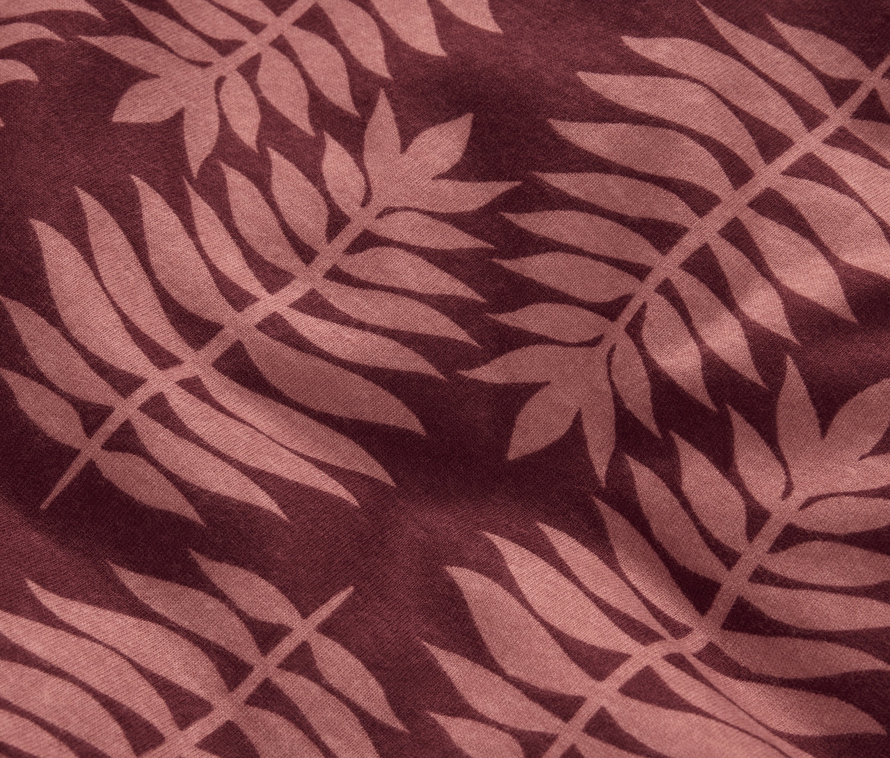 Detailný záber na zimnú žerzejovú posteľnú bielizeň štandardnej veľkosti s hnedým rastlinným vzorom.