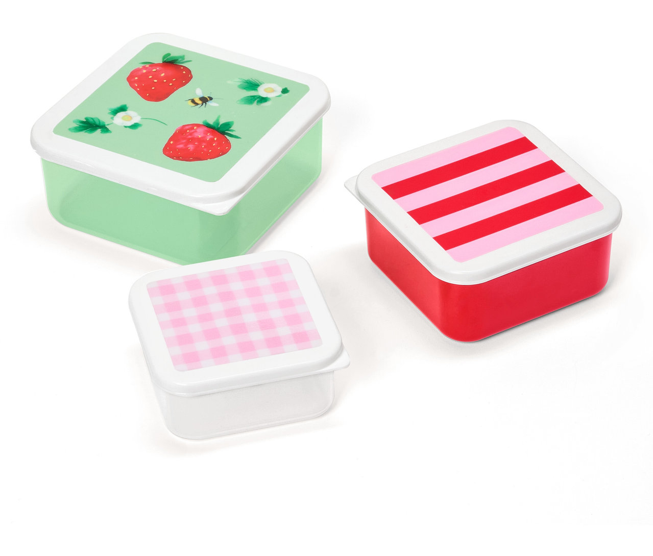 Tri štvorcové obedové boxy s rôznymi vzormi na viečkach: jahody, prúžky a kockovaný vzor.