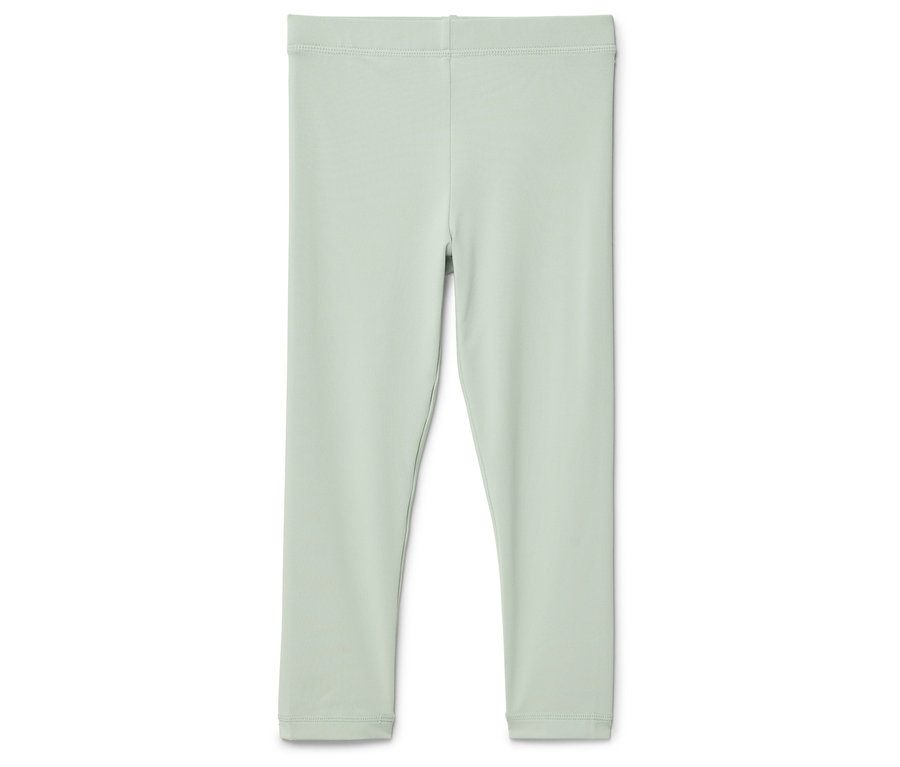 Svetlozelené legíny ležia na bielom pozadí.