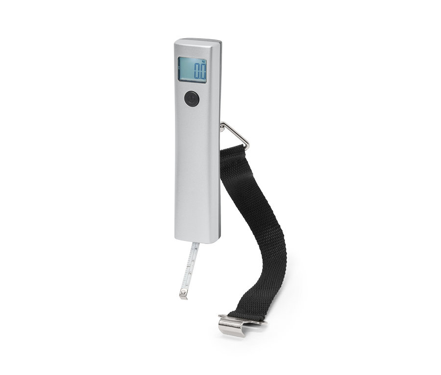 Na bielom pozadí je digitálna váha na kufre s čiernym popruhom a meracím pásmom.