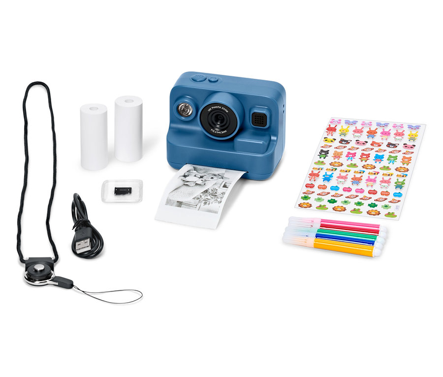Modrý fotoaparát s príslušenstvom, vrátane papiera, nálepiek, fixiek a USB kábla.