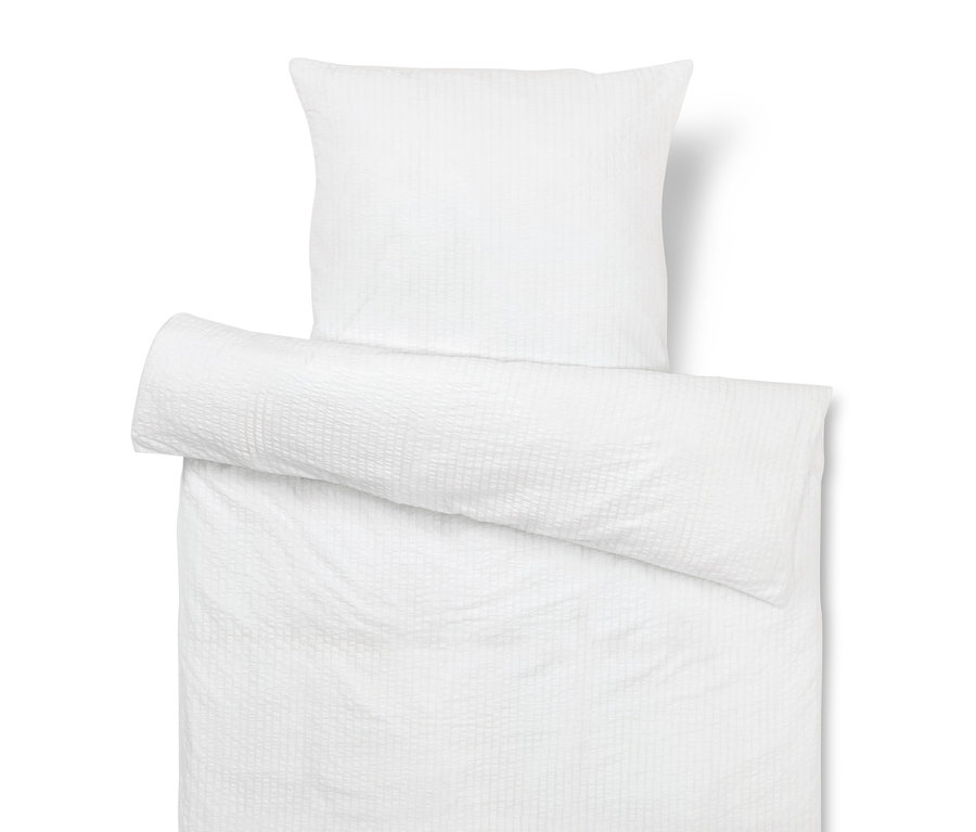 Biely obliečka na vankúš a prikrývku s textúrou.