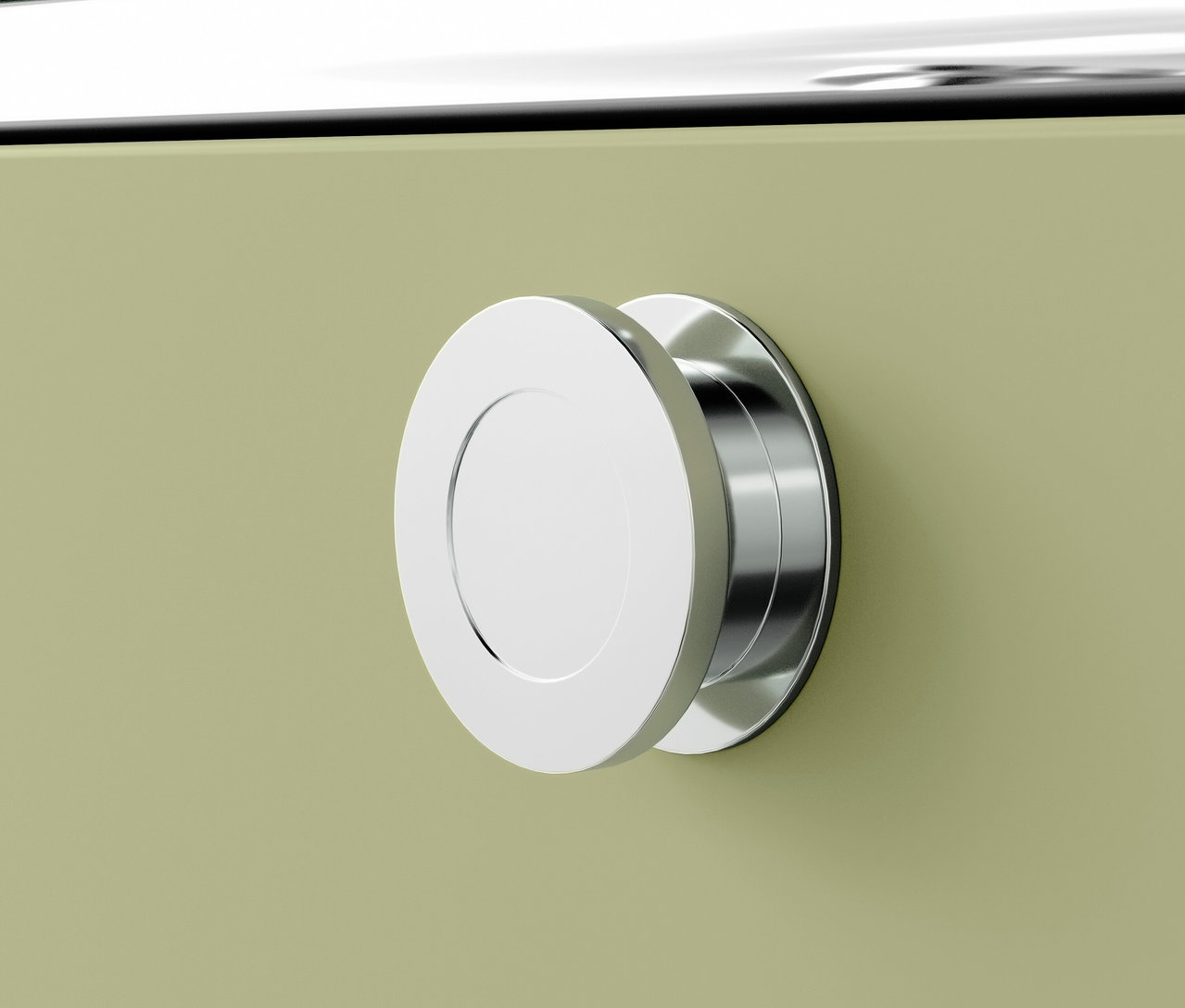 Detail chrómového okrúhleho úchytku na zelenom nábytku.