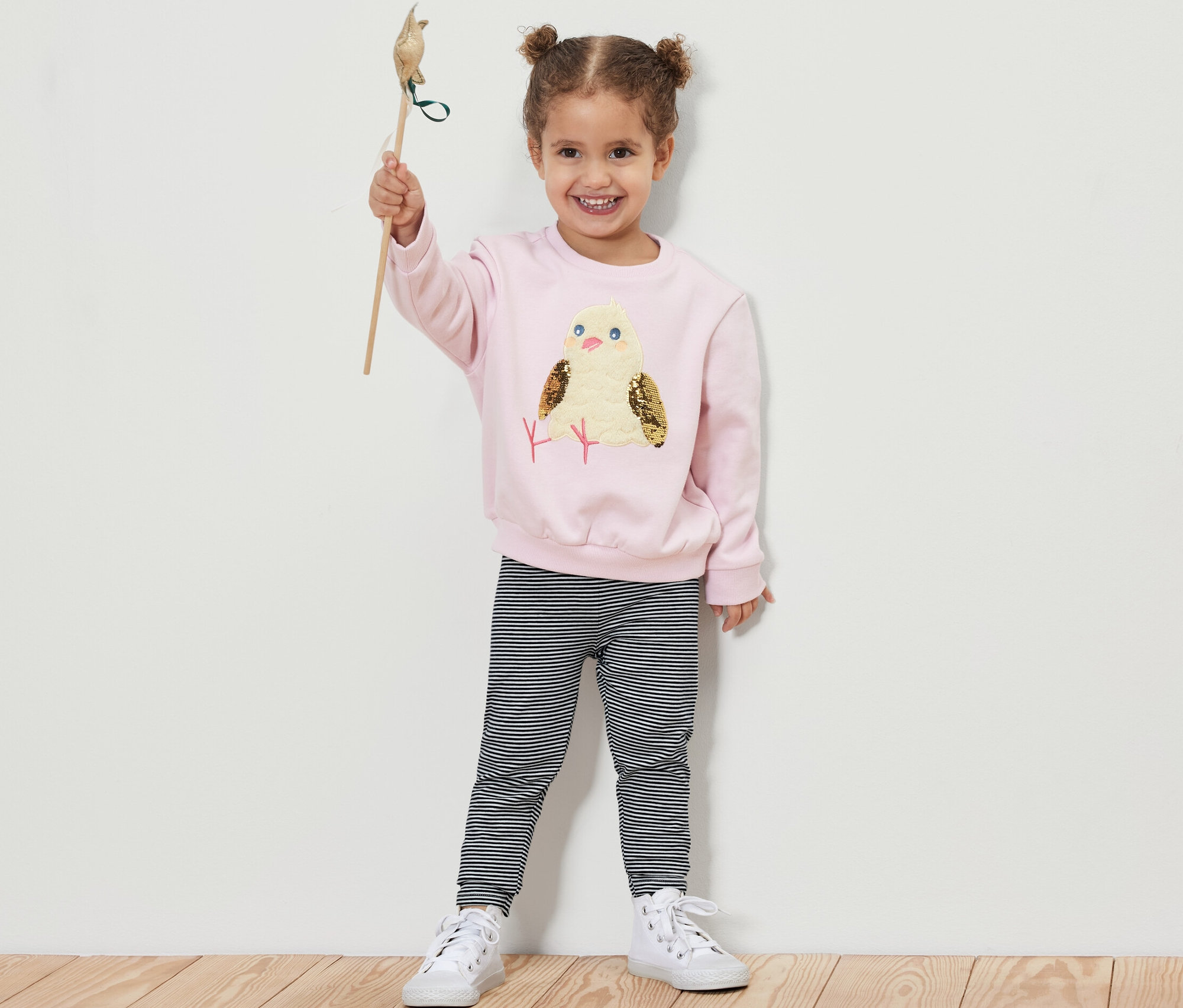 Dievča drží hračku vtáčika a má na sebe detské legínsy, 5 ks.