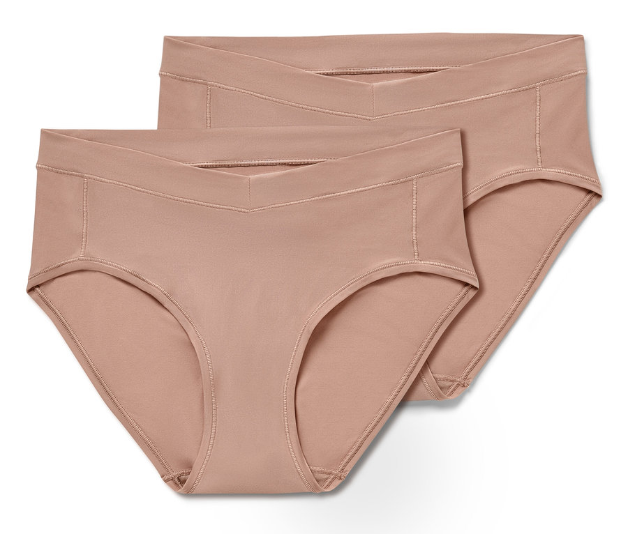 Dvoje béžové hipster nohavičky univerzálnej veľkosti ležia na sebe.