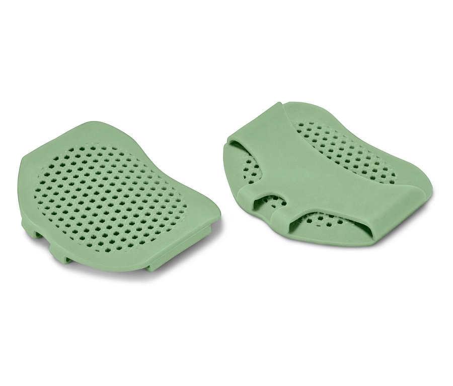 Dve zelené silikónové podložky s perforovaným povrchom.