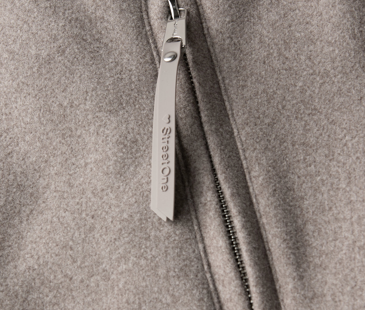 Detailný pohľad na krátky kabát Street One so zipsom a príveskom.