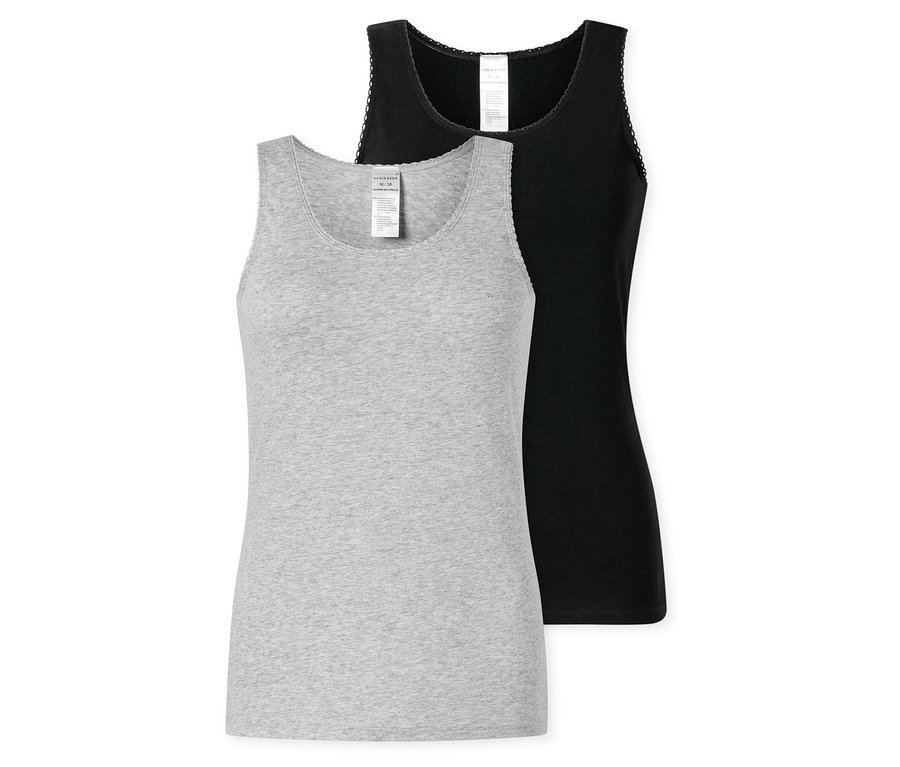 Dva topy SCHIESSER, jeden sivý a jeden čierny, ležia na sebe. Oba majú tenké ramienka a čipkovaný okraj.