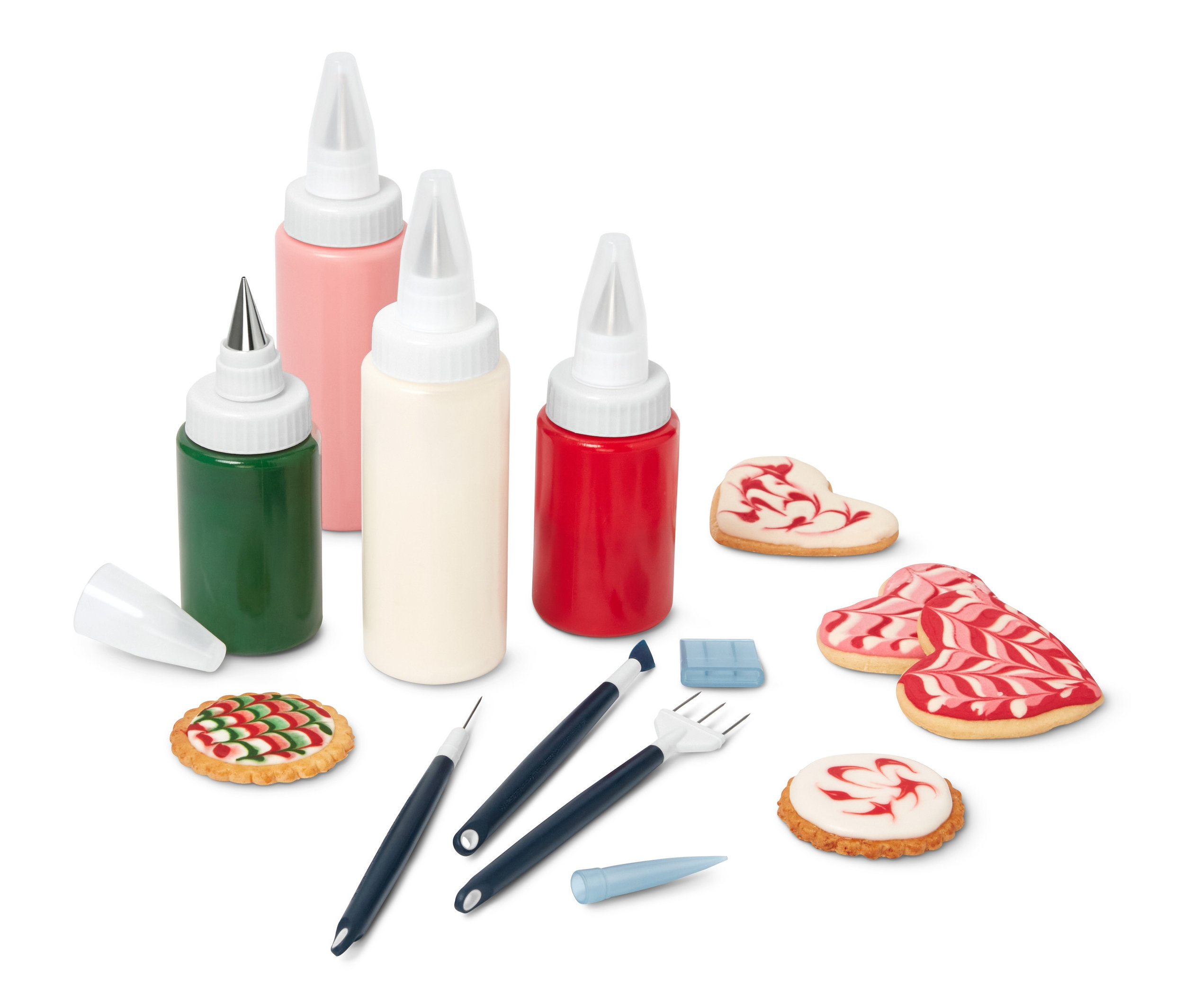 Súprava na kráľovskú glazúru s farebnými polevami, zdobiacimi nástrojmi a zdobenými sušienkami.