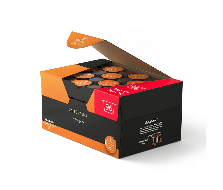 Otvorená čierna a oranžová krabica s 96 kávovými kapsulami Tchibo Cafissimo Caffè Crema.